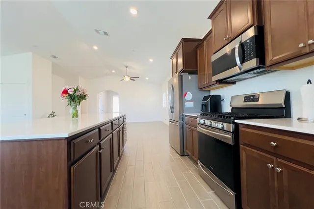 a kitchen with stainless steel appliances granite countertop a sink and stove top oven