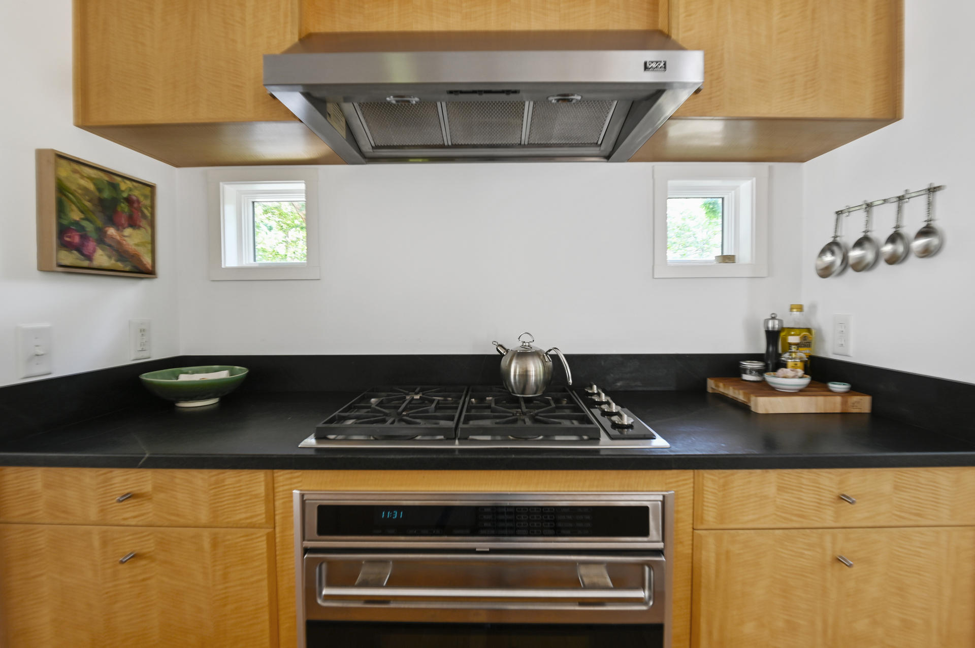 245 Cahoon Hollow Road Wellfleet, MA 02667 - Photo 17 of 36 a table with chairs and a stove top oven