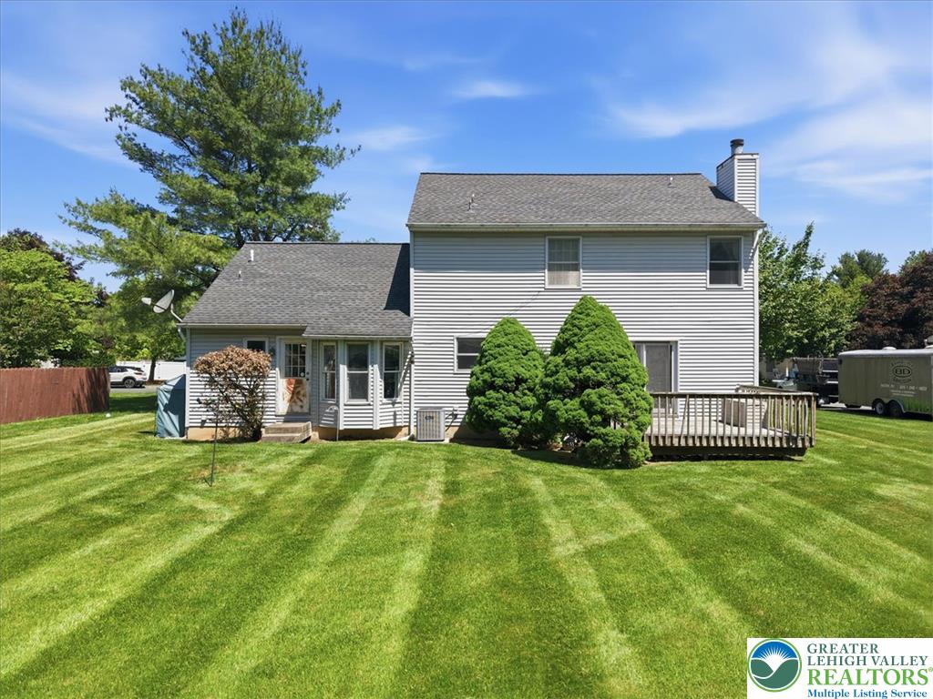 808 Hunter Road Easton, PA 18040 - Photo 35 of 41 An inviting backyard with a spacious deck and meticulously maintained lawn offers serene outdoor living.