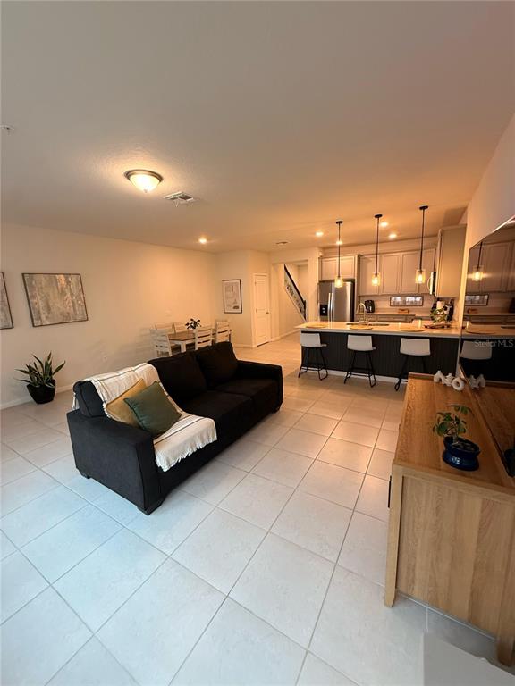 10923 Leafshore Loop Orlando, FL 32829 - Photo 12 of 44 a living room with furniture and a flat screen tv