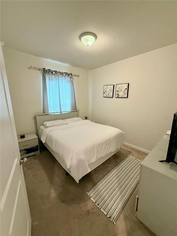 10923 Leafshore Loop Orlando, FL 32829 - Photo 17 of 44 a bedroom with a bed and a window