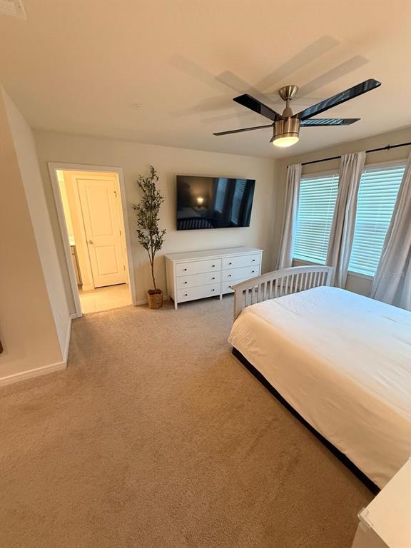 10923 Leafshore Loop Orlando, FL 32829 - Photo 26 of 44 a bedroom with a large bed and a window