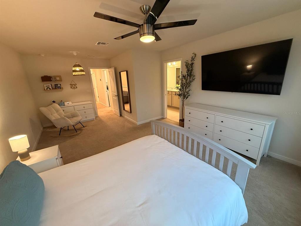 10923 Leafshore Loop Orlando, FL 32829 - Photo 27 of 44 a living room with furniture and a flat screen tv