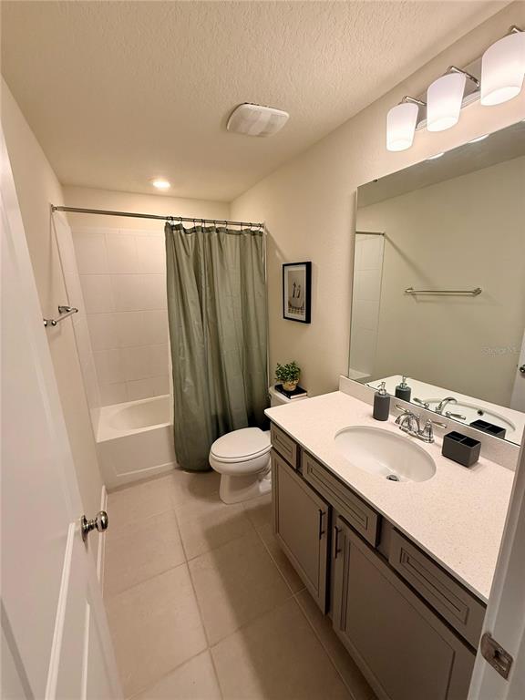 10923 Leafshore Loop Orlando, FL 32829 - Photo 31 of 44 a bathroom with a sink a toilet a mirror and shower