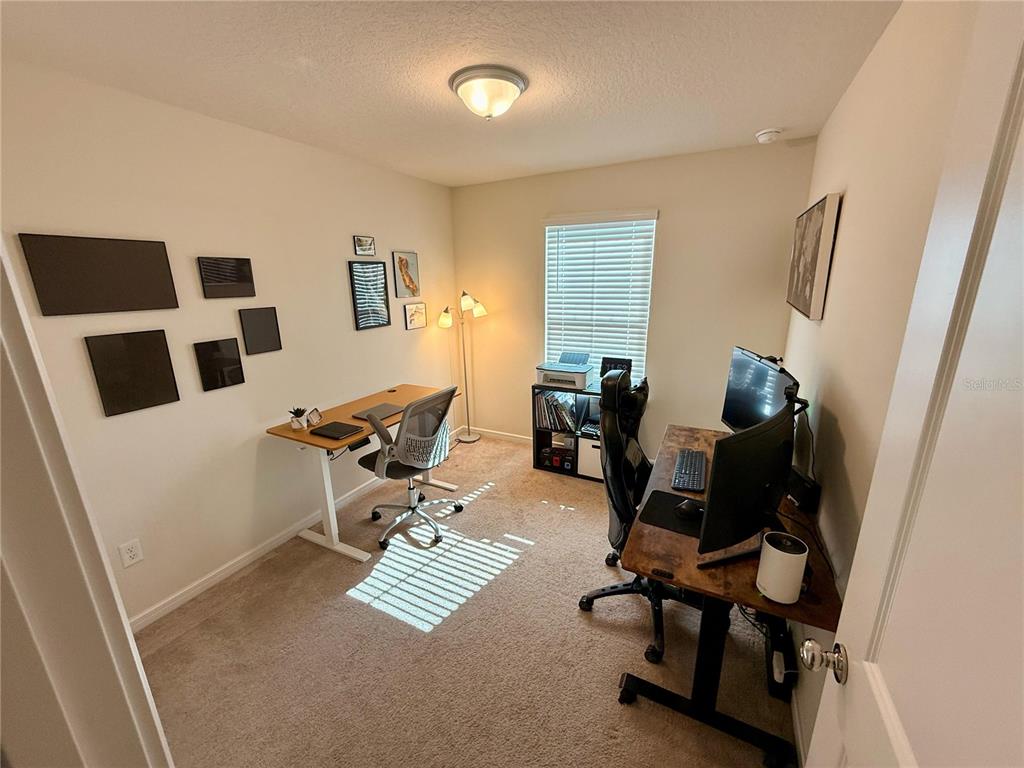 10923 Leafshore Loop Orlando, FL 32829 - Photo 32 of 44 a view of a workspace with furniture and a window