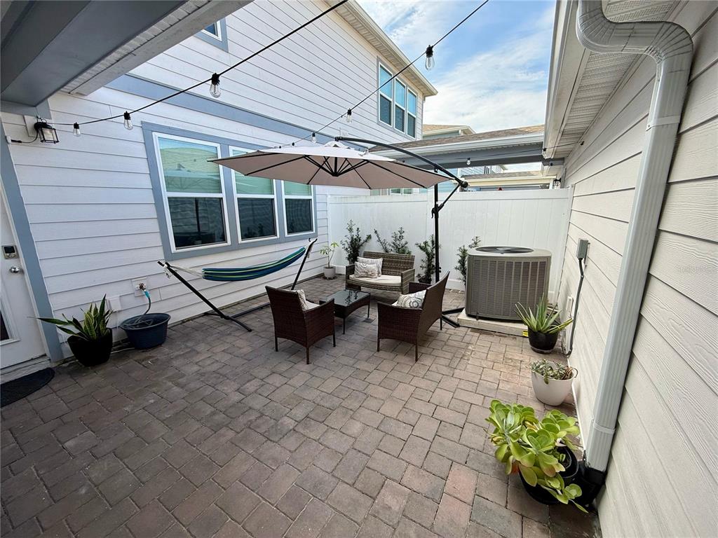 10923 Leafshore Loop Orlando, FL 32829 - Photo 33 of 44 a view of a patio with table and chairs and potted plants