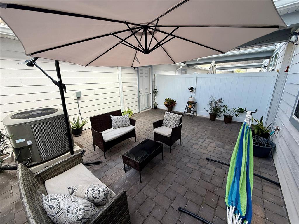 10923 Leafshore Loop Orlando, FL 32829 - Photo 34 of 44 a patio with patio couch and potted plants
