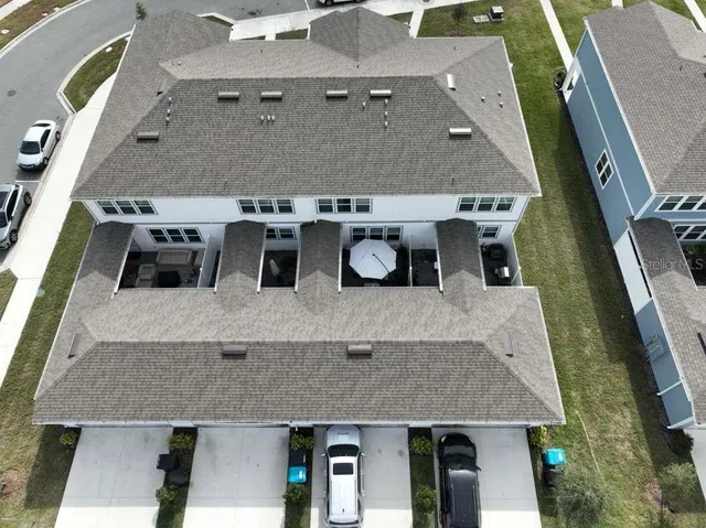 a aerial view of a house with table and chairs
