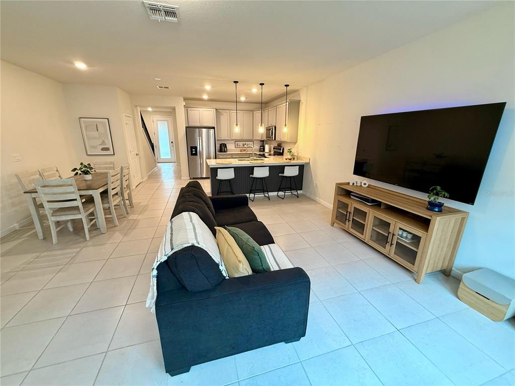 10923 Leafshore Loop Orlando, FL 32829 - Photo 9 of 44 a living room with furniture and a flat screen tv
