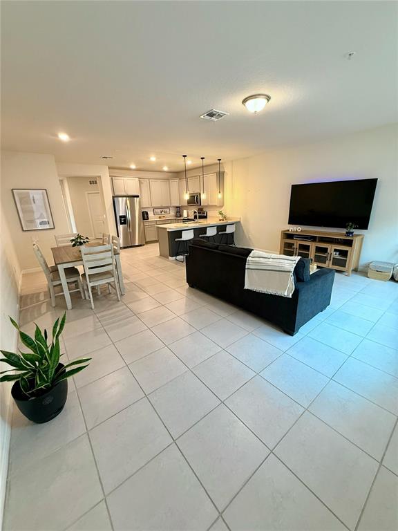 10923 Leafshore Loop Orlando, FL 32829 - Photo 10 of 44 a living room with furniture and a flat screen tv