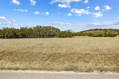 a view of a lake with sunset in background