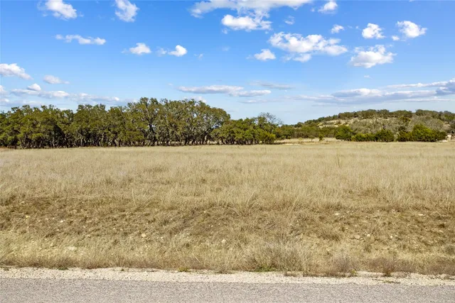 a view of a lake with sunset in background
