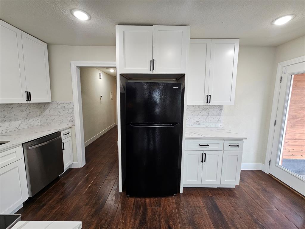 211 North Hampton Road Dallas, TX 75208 - Photo 11 of 22 Contemporary kitchen featuring white shaker cabinetry, stainless steel dishwasher, wood-finish flooring, recessed lighting, and a patterned tile backsplash