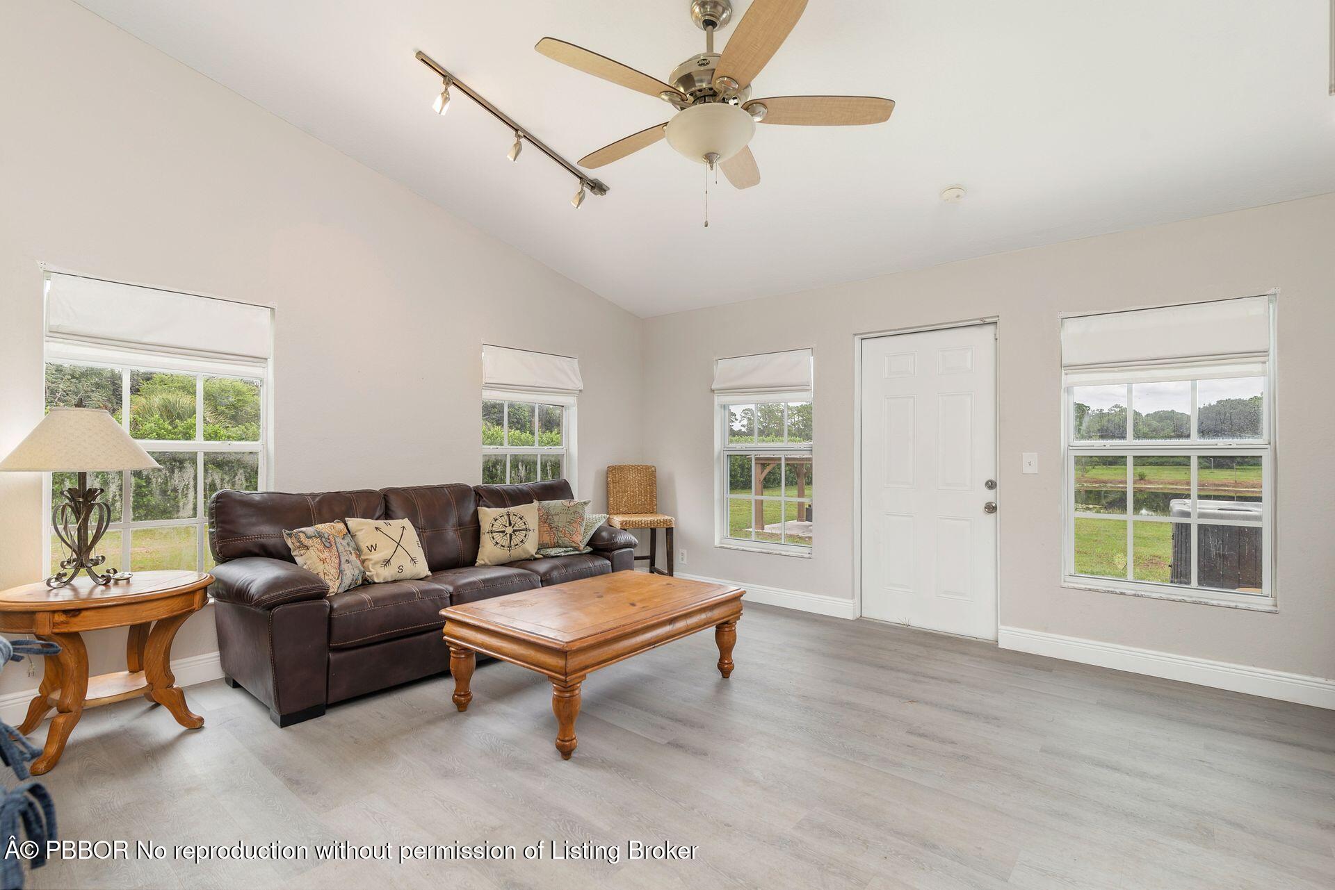 2770 E Road Loxahatchee, FL 33470 - Photo 20 of 51 a living room with furniture and a window