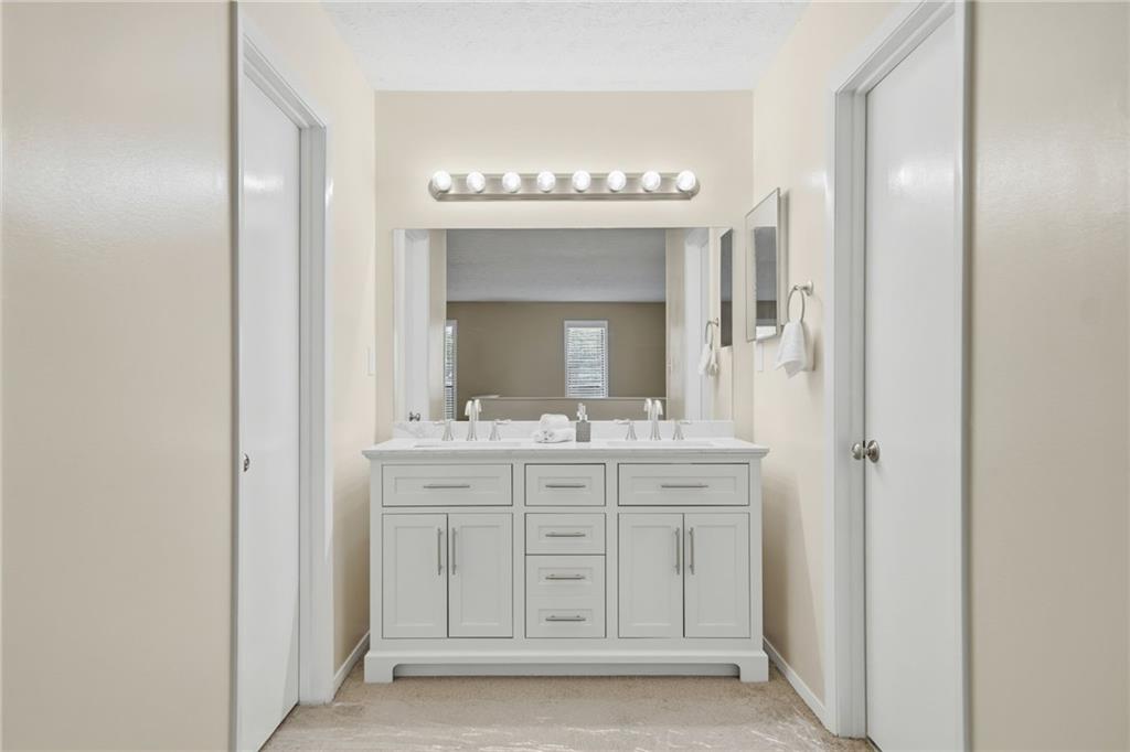 101 Park Ridge Circle Marietta, GA 30068 - Photo 22 of 52 a bathroom with a mirror and a sink