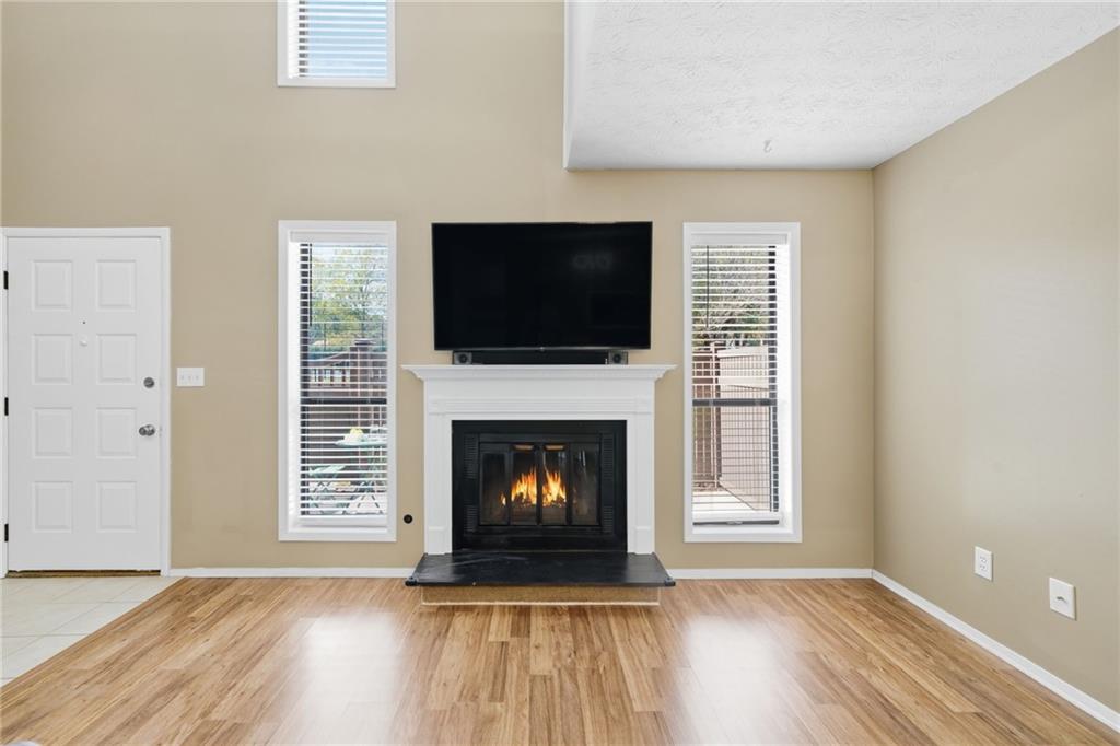 101 Park Ridge Circle Marietta, GA 30068 - Photo 8 of 52 a living room with a fireplace and a flat screen tv