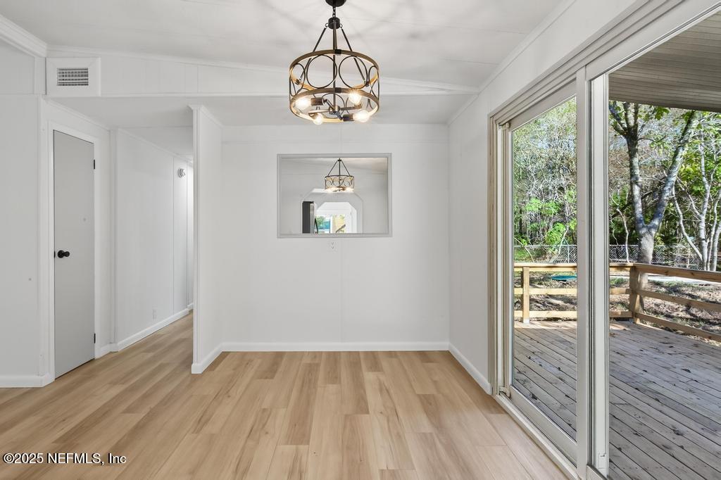 560 Quarter Horse Lane Bunnell, FL 32110 - Photo 24 of 66 a view of an empty room with wooden floor and a window