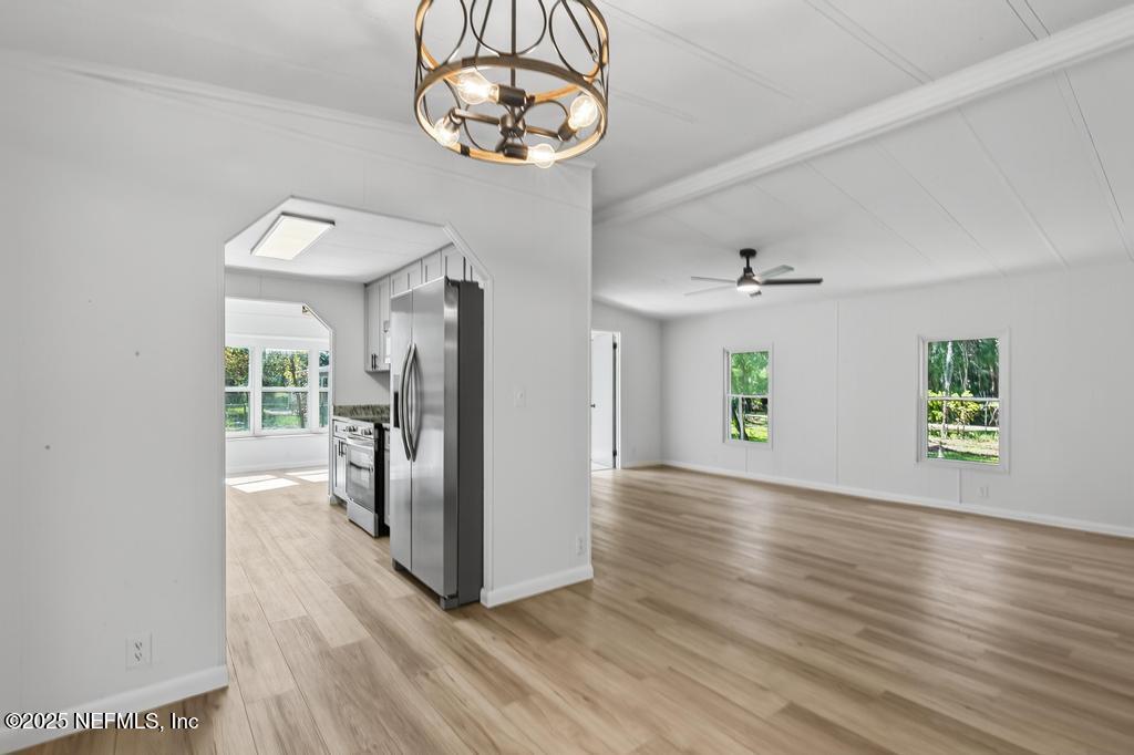 560 Quarter Horse Lane Bunnell, FL 32110 - Photo 28 of 66 an empty room with wooden floor and windows