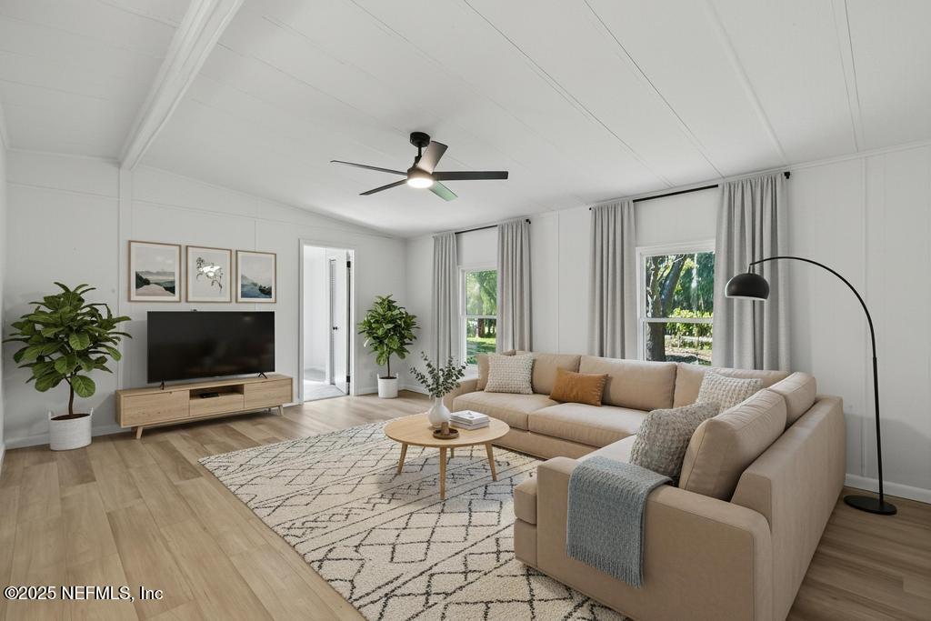 560 Quarter Horse Lane Bunnell, FL 32110 - Photo 30 of 66 a living room with furniture a flat screen tv and a potted plant