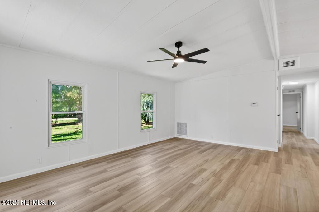 560 Quarter Horse Lane Bunnell, FL 32110 - Photo 34 of 66 a view of empty room with wooden floor and window