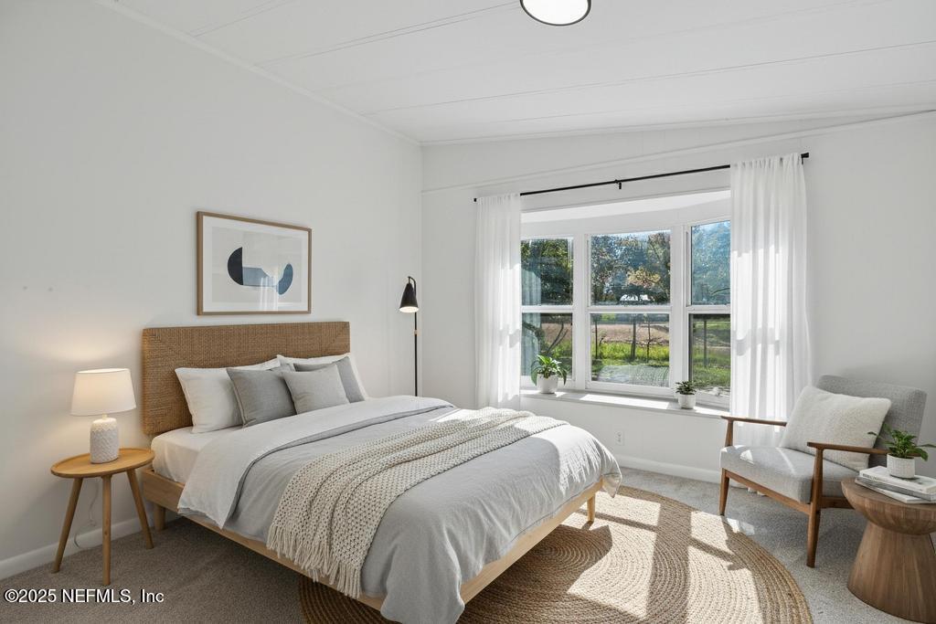 560 Quarter Horse Lane Bunnell, FL 32110 - Photo 35 of 66 a bedroom with a bed and a large window
