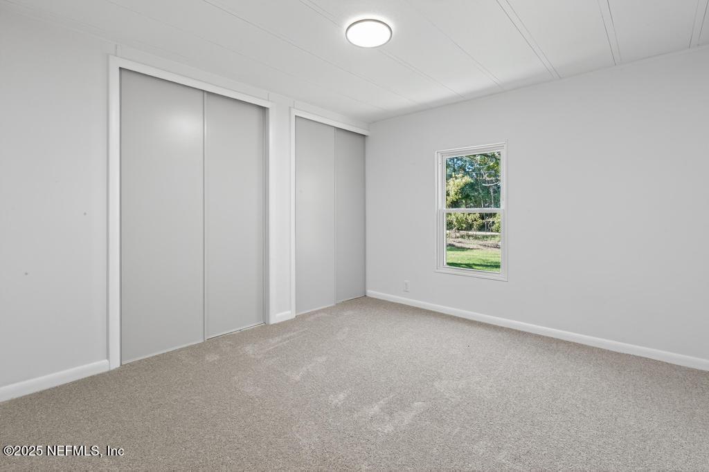 560 Quarter Horse Lane Bunnell, FL 32110 - Photo 43 of 66 an empty room with windows and closet