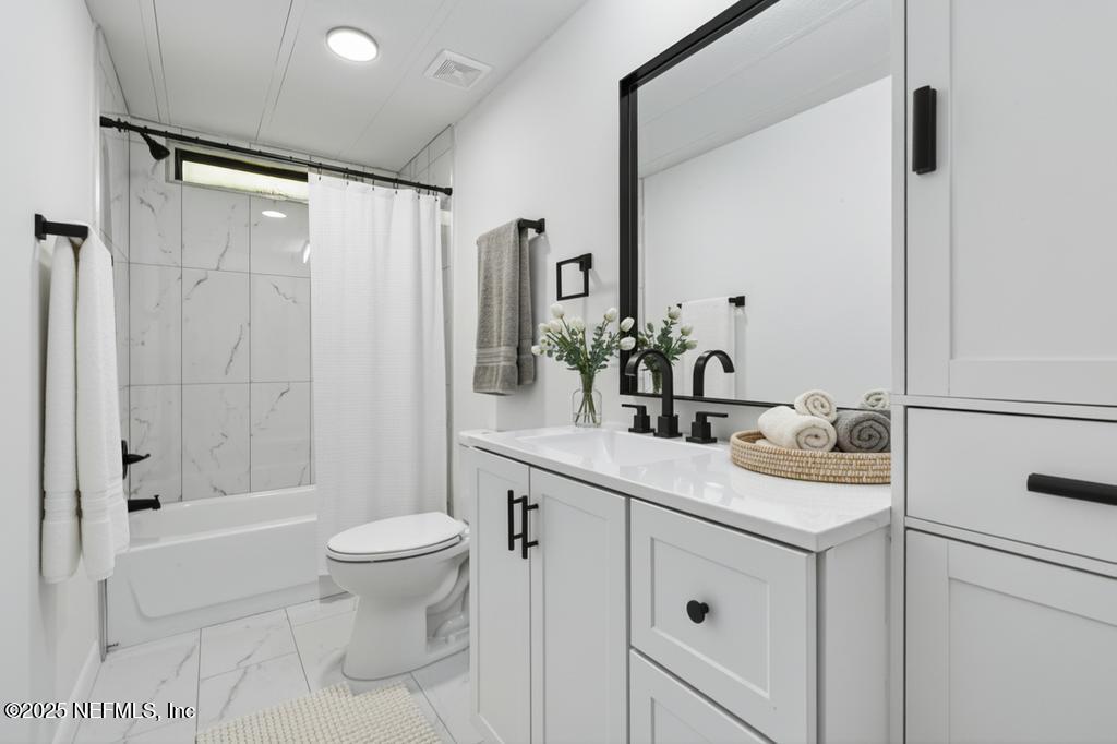 560 Quarter Horse Lane Bunnell, FL 32110 - Photo 45 of 66 a bathroom with a sink a toilet and shower