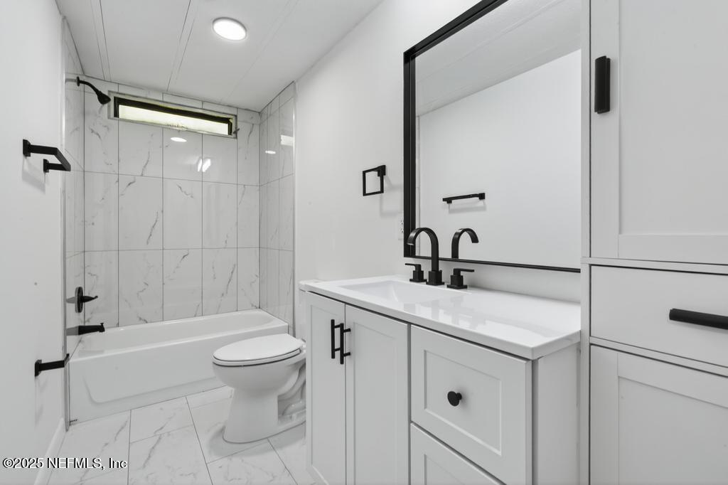 560 Quarter Horse Lane Bunnell, FL 32110 - Photo 46 of 66 a bathroom with a sink a toilet and shower