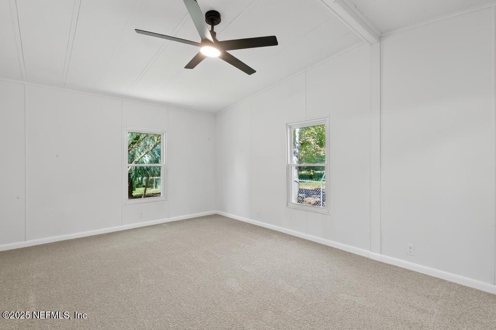 560 Quarter Horse Lane Bunnell, FL 32110 - Photo 49 of 66 an empty room with windows and ceiling fan