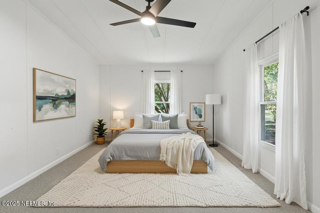 560 Quarter Horse Lane Bunnell, FL 32110 - Photo 50 of 66 a bedroom with a large bed and a chandelier