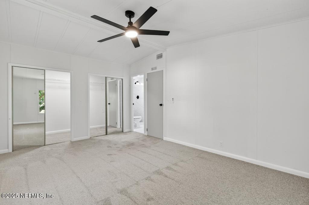 560 Quarter Horse Lane Bunnell, FL 32110 - Photo 52 of 66 an empty room with closet and a ceiling fan