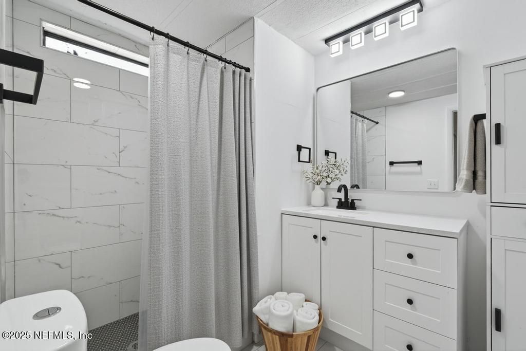 560 Quarter Horse Lane Bunnell, FL 32110 - Photo 56 of 66 a bathroom with a sink a toilet a large mirror and shower