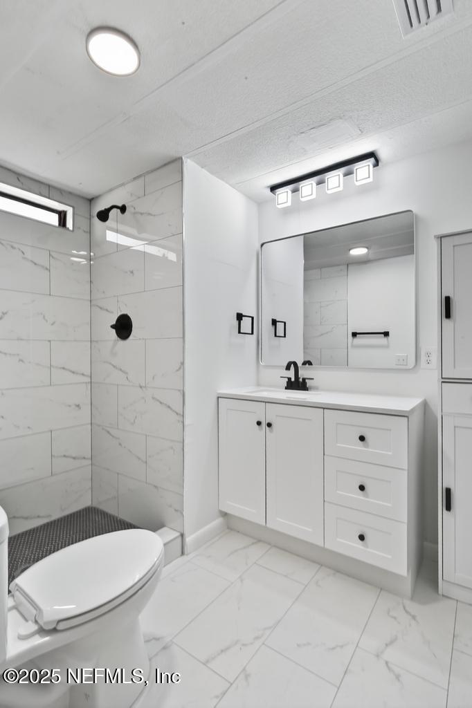 560 Quarter Horse Lane Bunnell, FL 32110 - Photo 58 of 66 a bathroom with a toilet a sink shower and mirror