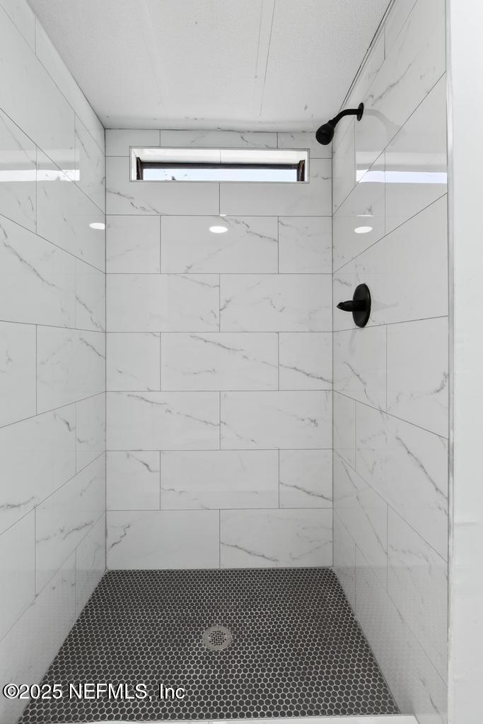 560 Quarter Horse Lane Bunnell, FL 32110 - Photo 59 of 66 a bathroom with a glass shower door