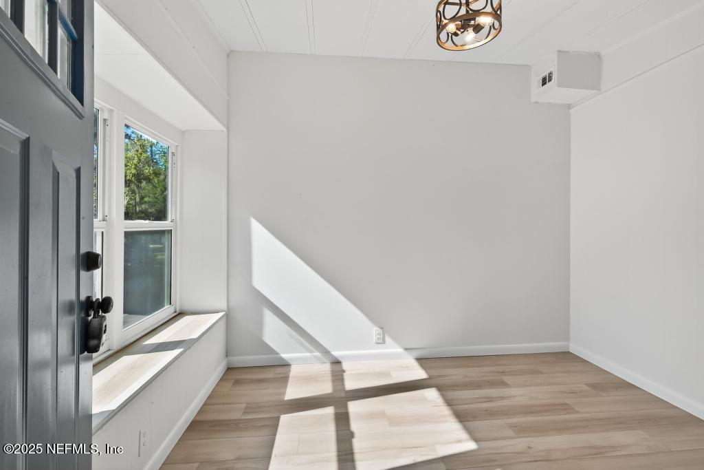 560 Quarter Horse Lane Bunnell, FL 32110 - Photo 10 of 66 a view of a hallway with wooden floor and staircase