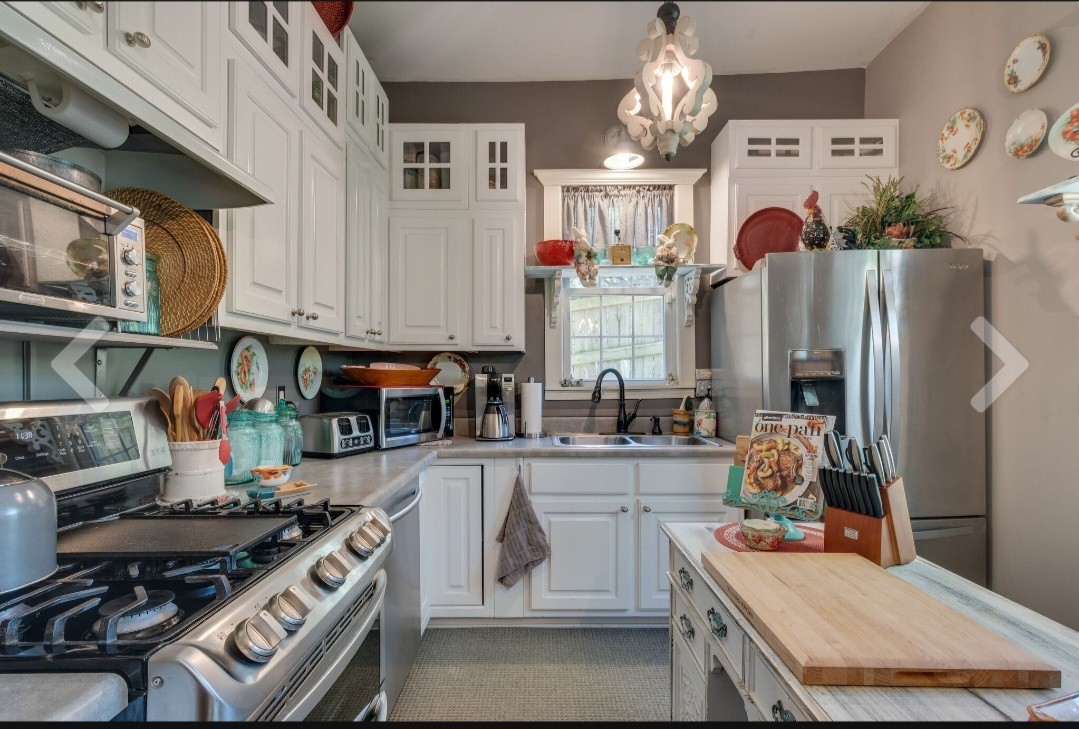 210 South 6th Street Pulaski, TN 38478 - Photo 14 of 44 a kitchen with stainless steel appliances granite countertop a stove and a refrigerator