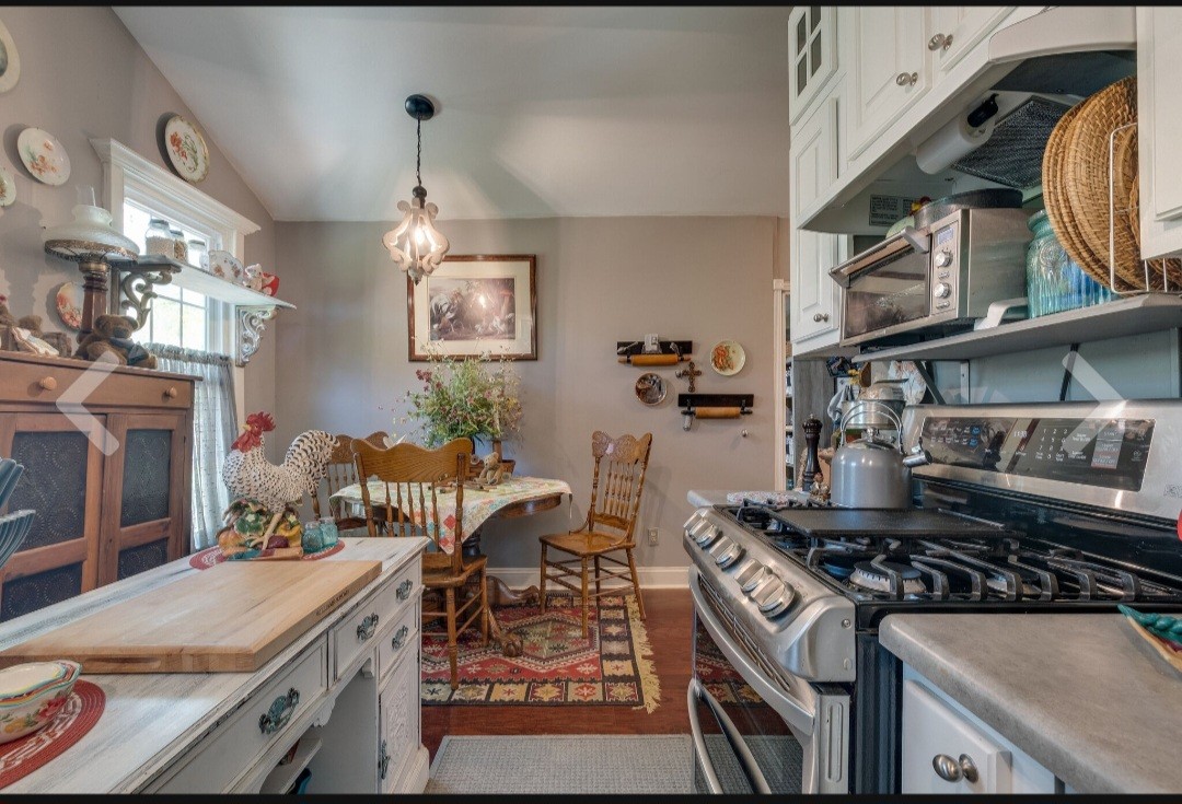 210 South 6th Street Pulaski, TN 38478 - Photo 17 of 44 a kitchen with a stove and a wooden floor