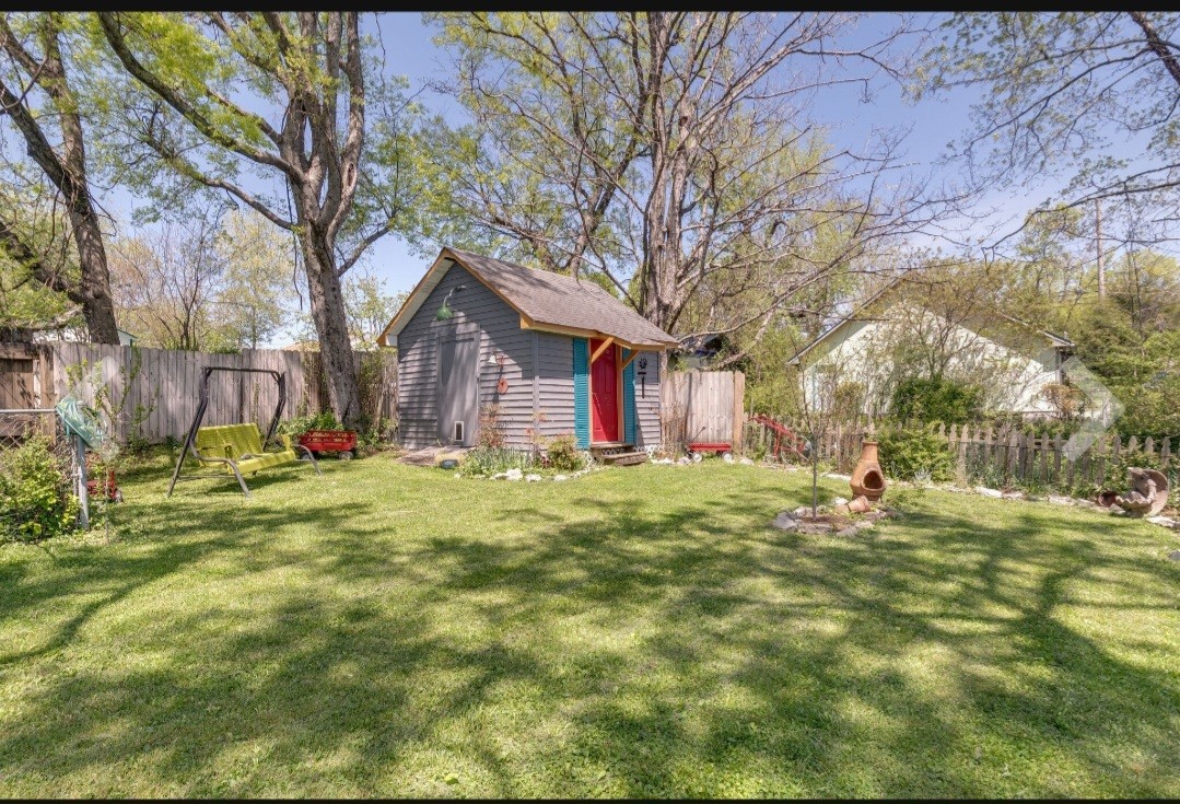 210 South 6th Street Pulaski, TN 38478 - Photo 35 of 44 a backyard of a house with large trees and outdoor seating