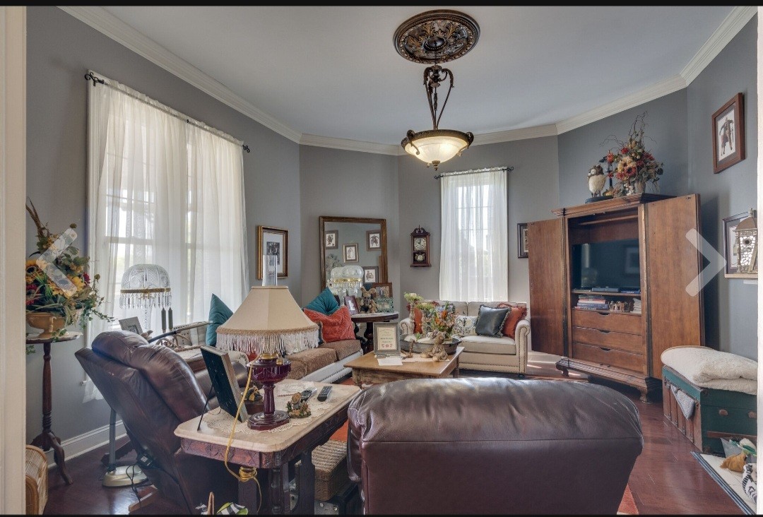 210 South 6th Street Pulaski, TN 38478 - Photo 10 of 44 a living room with furniture a chandelier and a flat screen tv