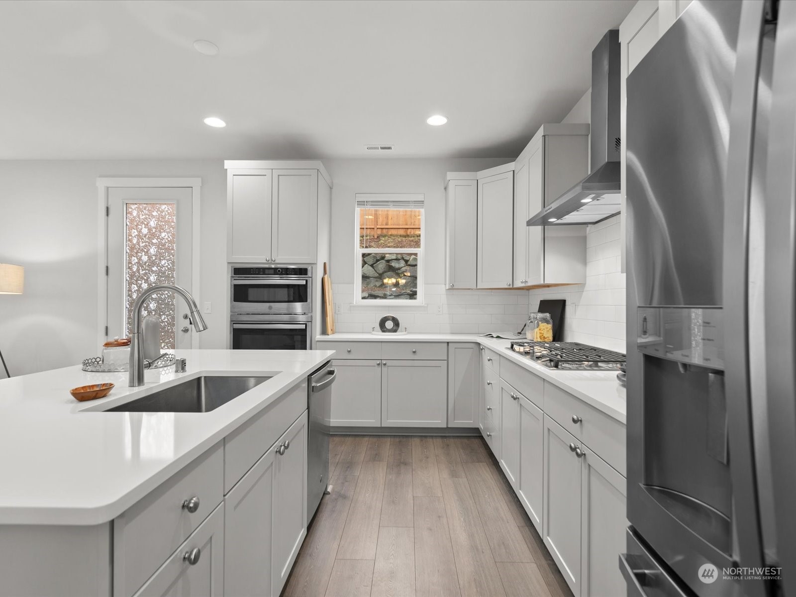 9752 Prospect Place Gig Harbor, WA 98332 - Photo 11 of 40 a kitchen with white cabinets and sink
