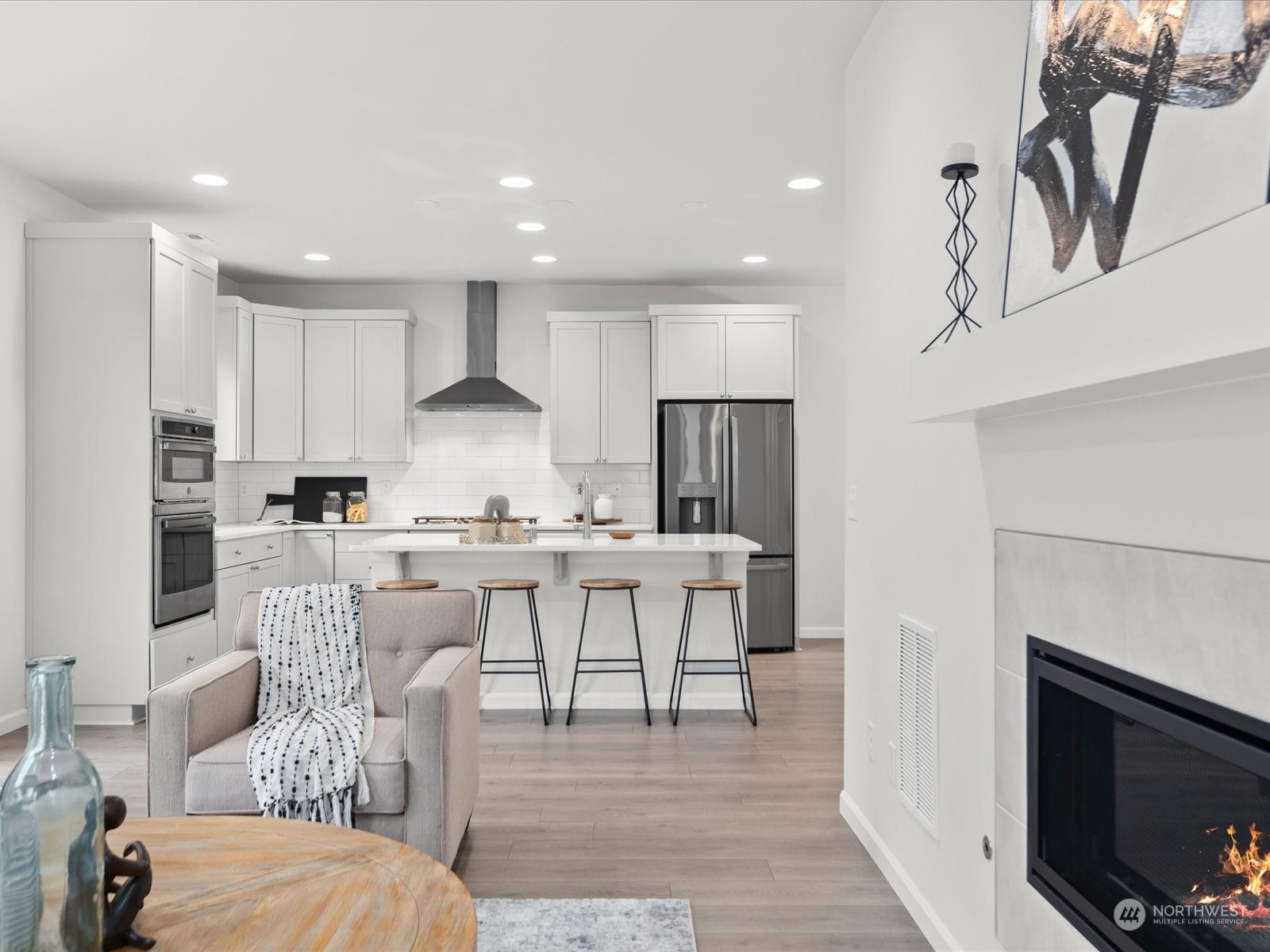 9752 Prospect Place Gig Harbor, WA 98332 - Photo 17 of 40 a view of kitchen with stainless steel appliances granite countertop a stove a sink a refrigerator and a dining table with white countertops