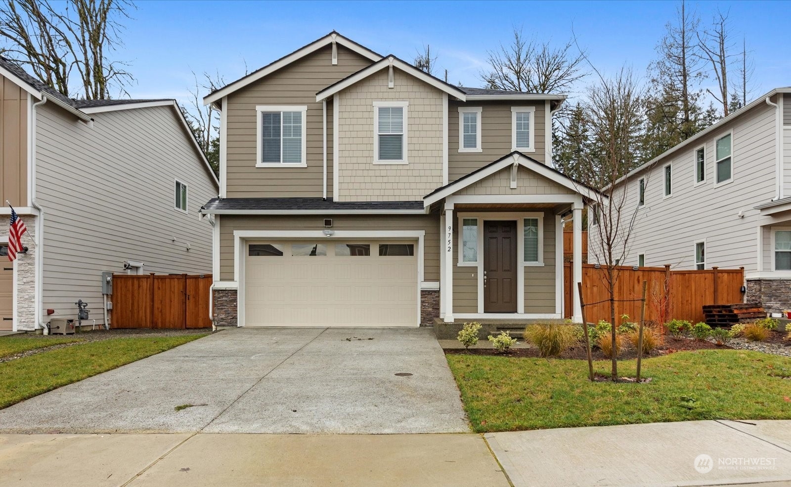 9752 Prospect Place Gig Harbor, WA 98332 - Photo 2 of 40 a front view of a house with a garden