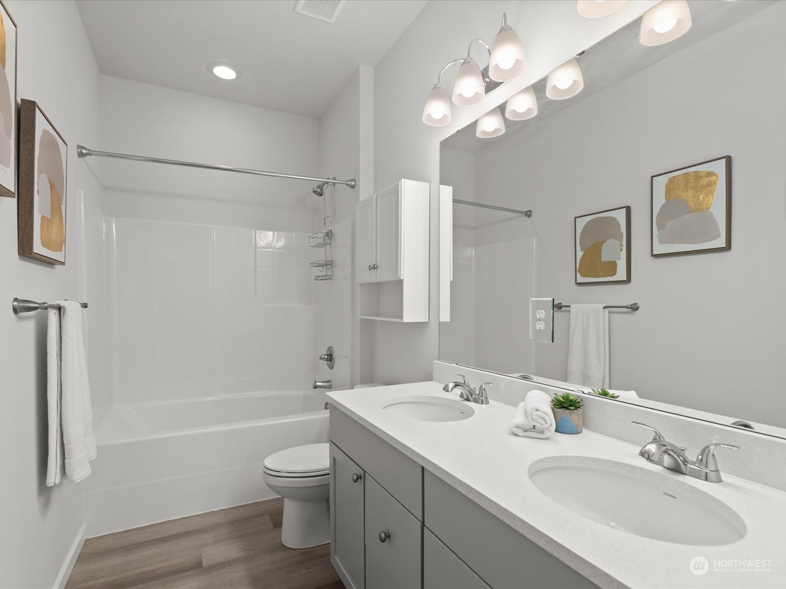 9752 Prospect Place Gig Harbor, WA 98332 - Photo 25 of 40 a bathroom with a toilet a sink a tub and a mirror