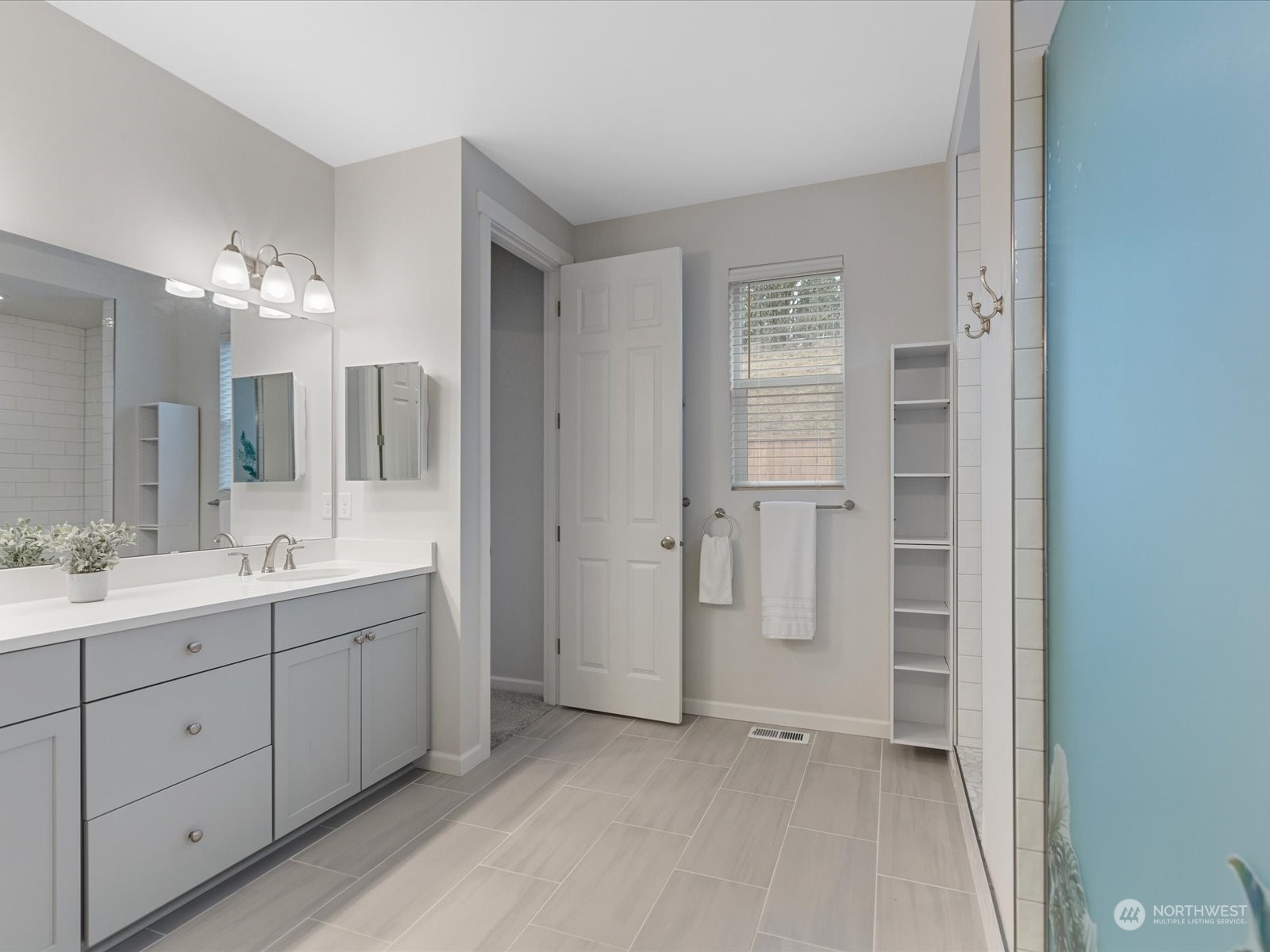 9752 Prospect Place Gig Harbor, WA 98332 - Photo 30 of 40 a bathroom with a double vanity sink and mirror