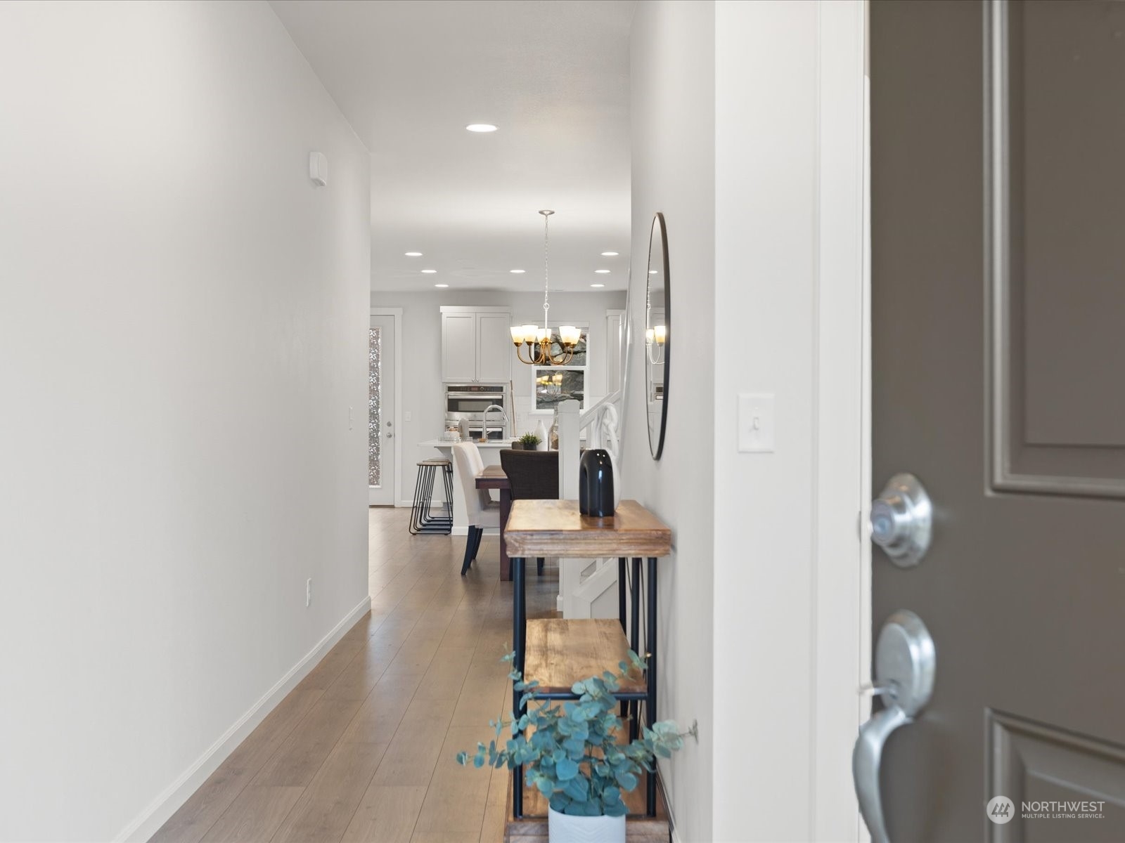 9752 Prospect Place Gig Harbor, WA 98332 - Photo 5 of 40 a dining room with furniture and a chandelier