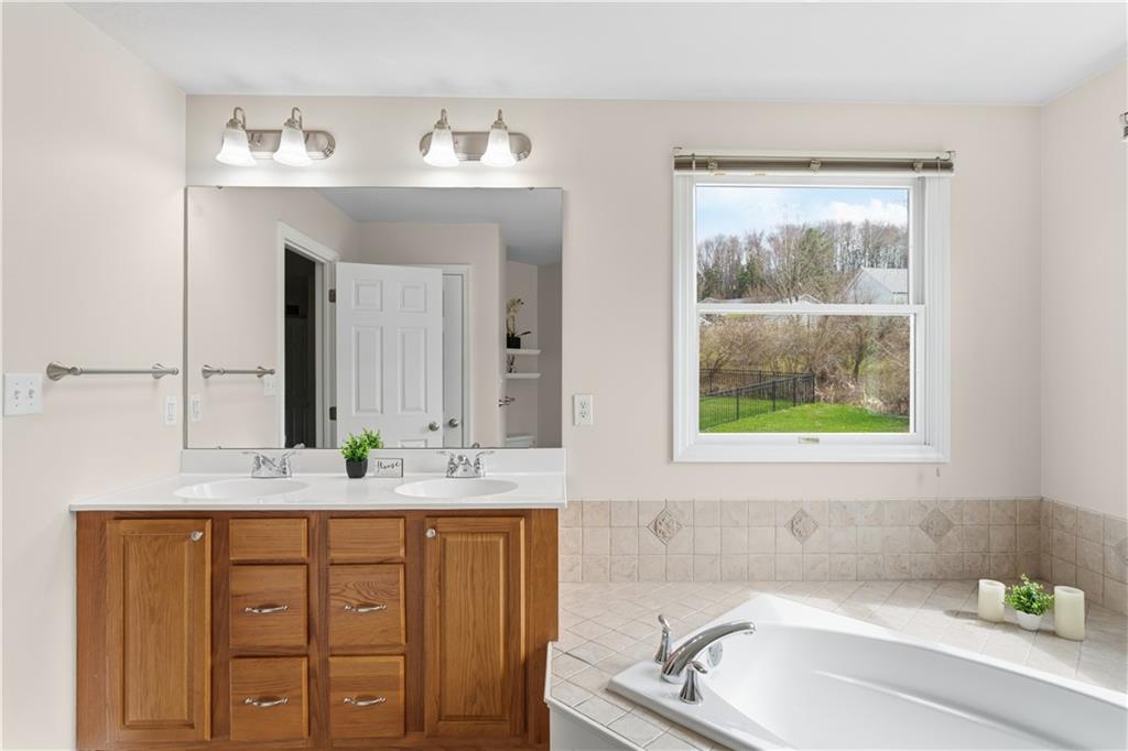 237 Morning Grove Lane Valencia, PA 16059 - Photo 28 of 50 a bathroom with a granite countertop sink and a window