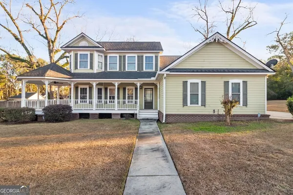 a front view of a house with a yard and porch