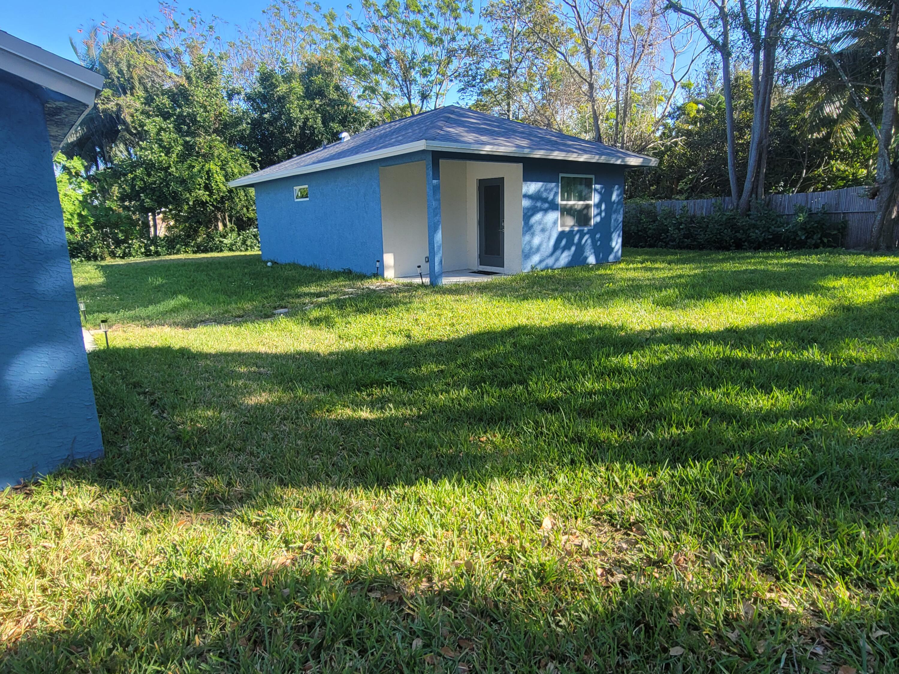 106 East Chandler Road Cloud Lake, FL 33406 - Photo 2 of 10 a view of a house with a yard