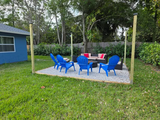 a view of an chairs and table in patio