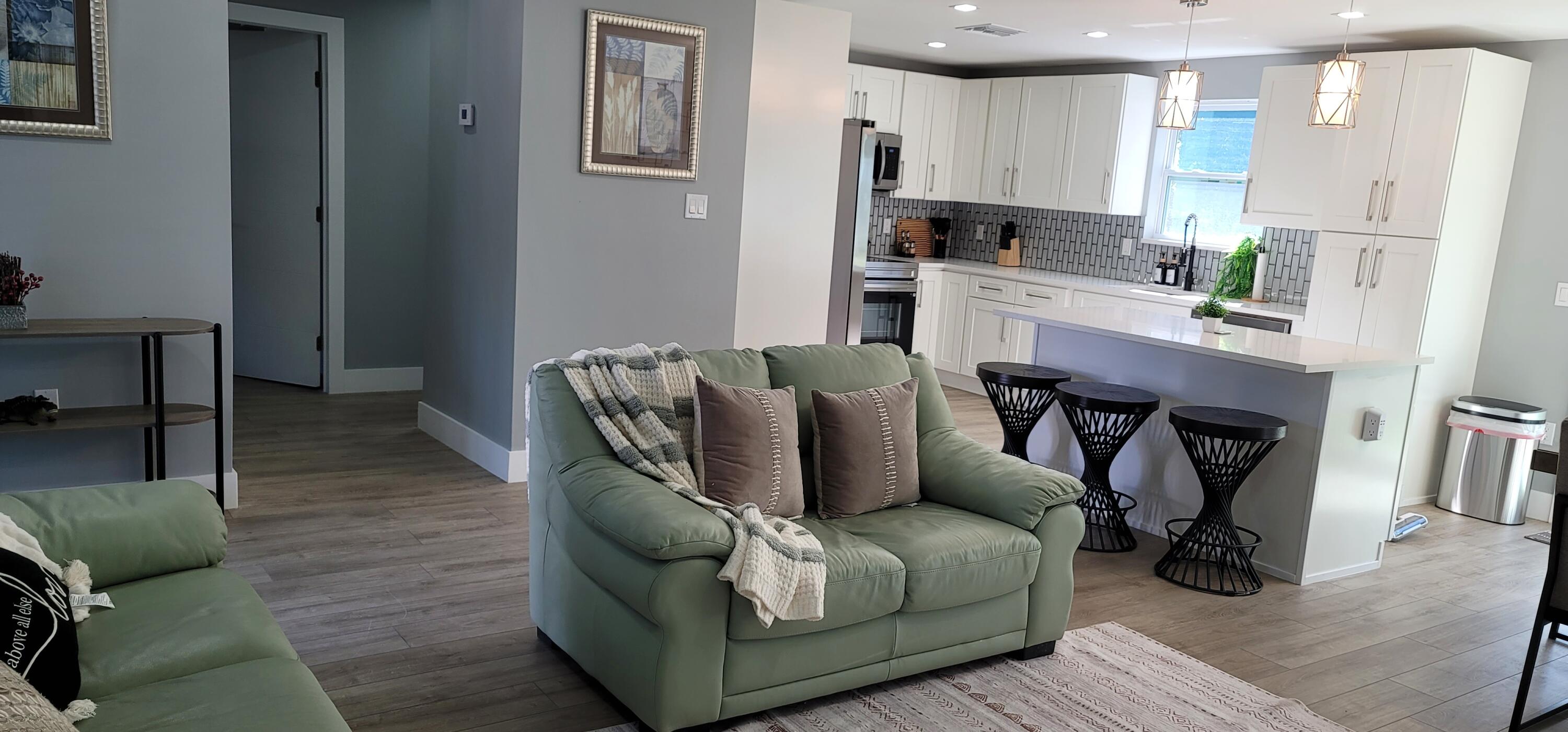 106 East Chandler Road Cloud Lake, FL 33406 - Photo 5 of 10 a living room with furniture and a refrigerator